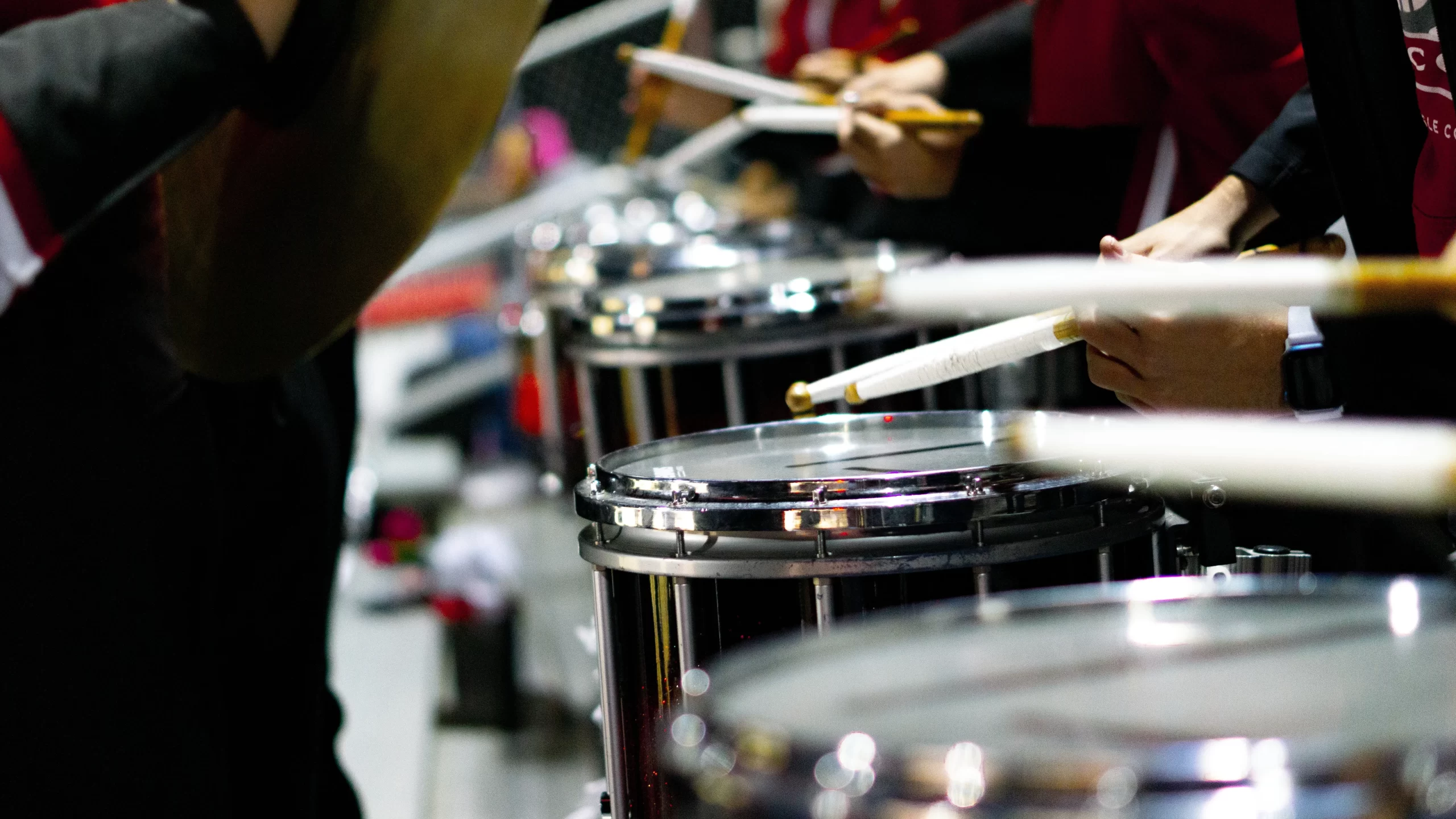 A group of snare drummers in a marching band